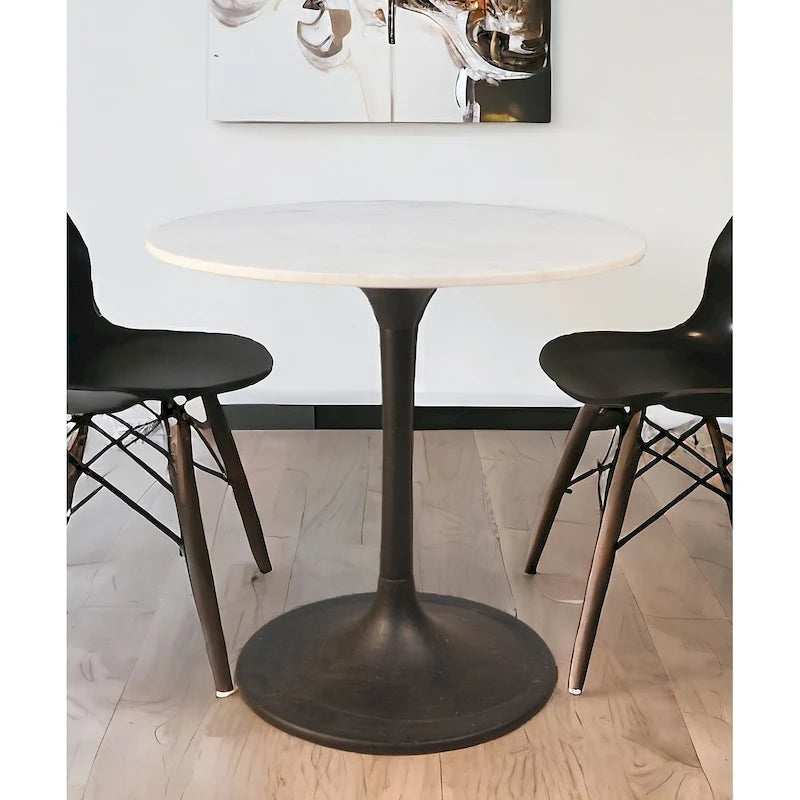 Table à manger ronde plateau marbre blanc piétement fer noir style moderne